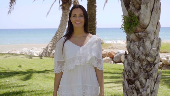 Smiling Woman Walking Near Palm Trees