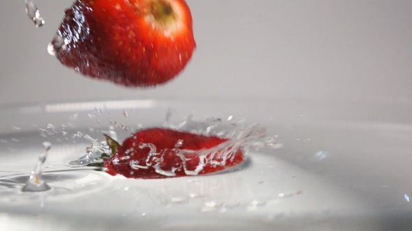 Three Strawberries Plung Into Water