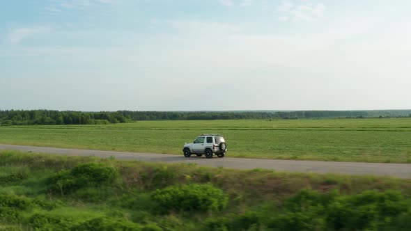 Aerial View of a Car Driving on a Country Road