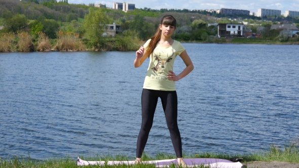 Fitness Girl Exercising Outdoors Beside The River Doing Squat Exercise 
