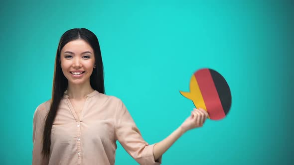 Smiling Girl Holding German Flag Speech Bubble, Learning Language, Travel Ideas