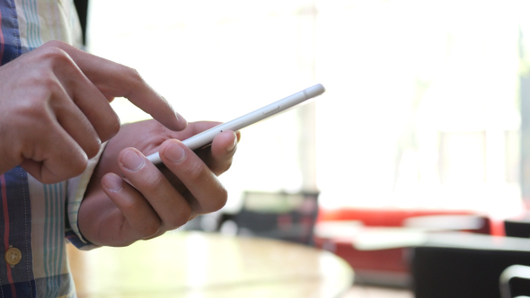 African Man Typing on Smartphone