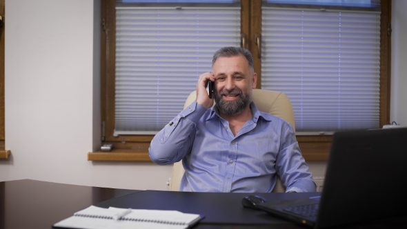 Businessman Is Talking With a Friend On The Phone