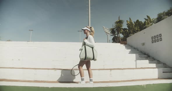 Beautiful Tennis Player Walking Along Court