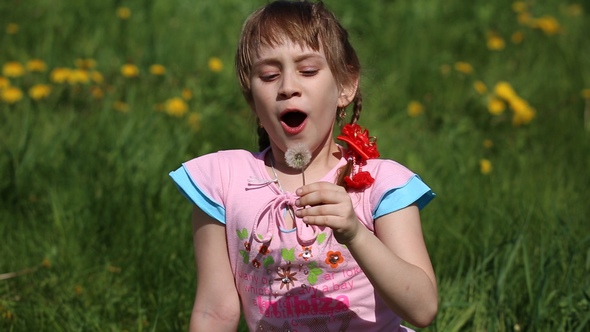 Girl Blowing on a Dandelion