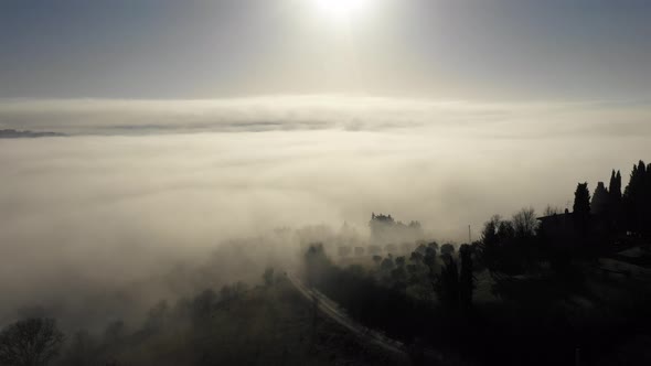 Aerial view of morning fog over forest in Umbria, Italy