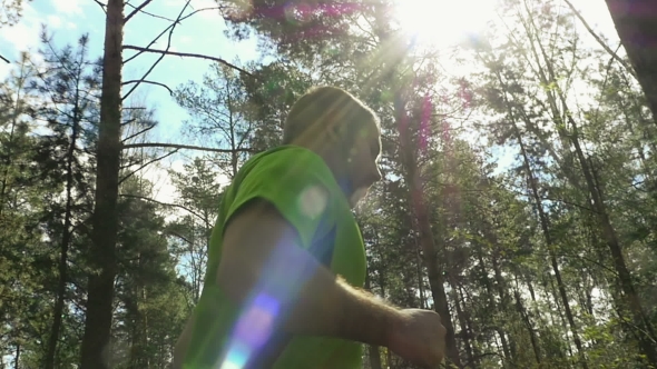 Man Is Jogging At The Forest