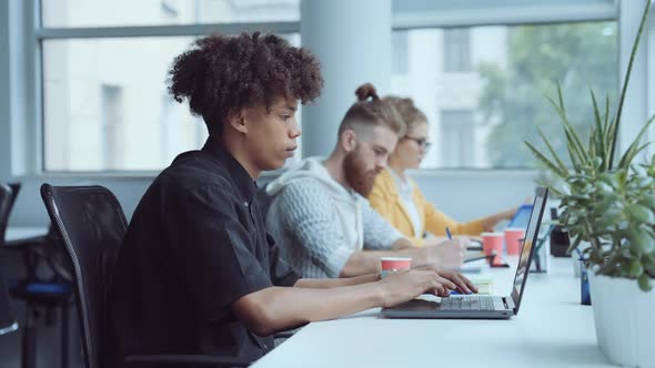 Black Man Working on Laptop in Office