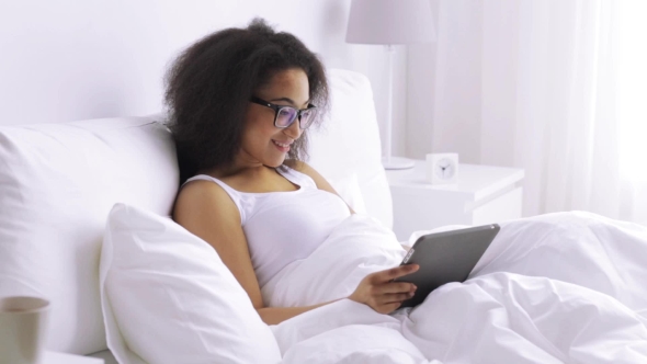 African Woman With Tablet Pc In Bed At Home 139