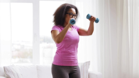 African Woman Exercising With Dumbbells At Home 132