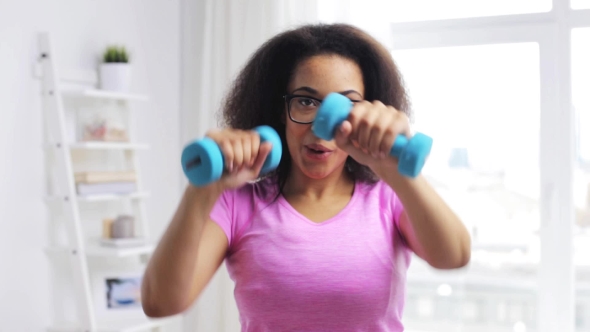 African Woman Exercising With Dumbbells At Home 71