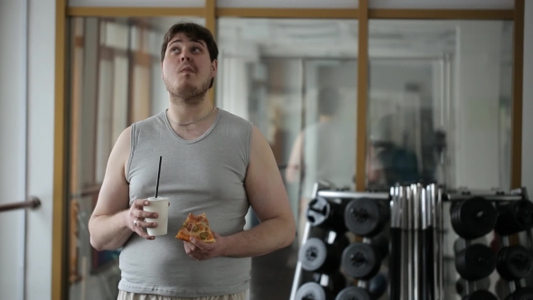 Nonprofessional Actor On The Set Of Advertising Unnaturally Pretends To Eat Pizza