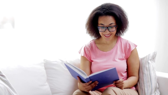 African American Young Woman Reading Book At Home 89