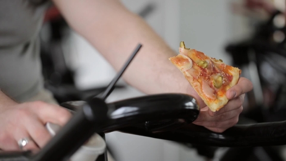 Fat Man Eating Pizza, Spinning Exercise Bike Pedals