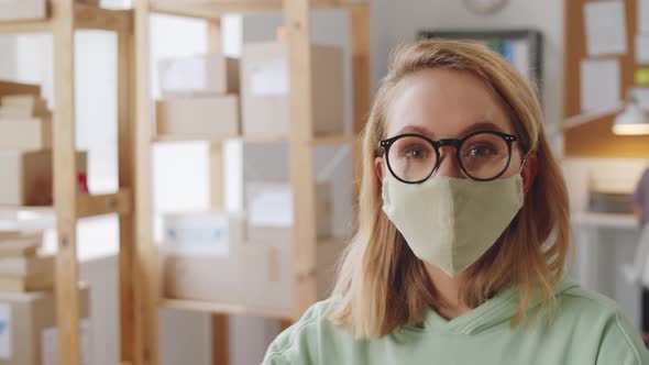 Portrait of Young Lady in Protective Face Mask at Work
