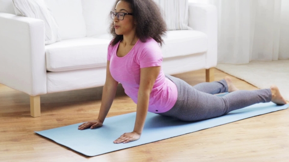 Happy African Woman Exercising On Mat At Home 123