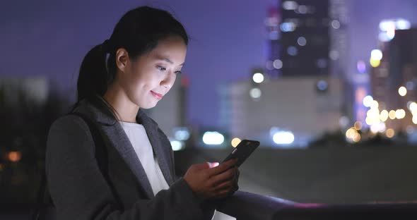 Woman use of mobile phone in city