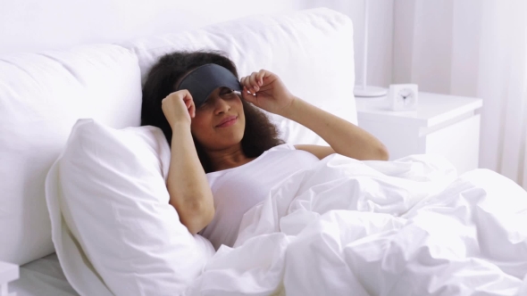 African Woman With Sleeping Mask In Bed At Home 148