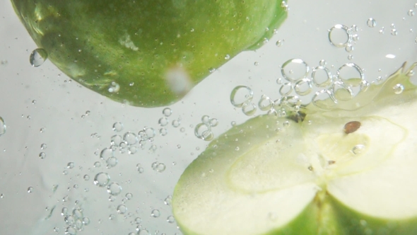 Two Apple Halfs Plung Into Water
