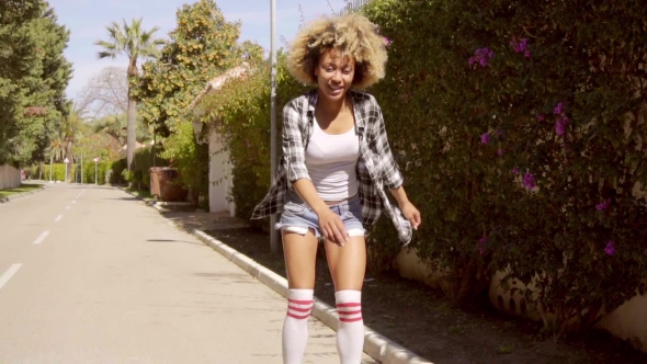 Black Woman Skating Down Mediterranean Street