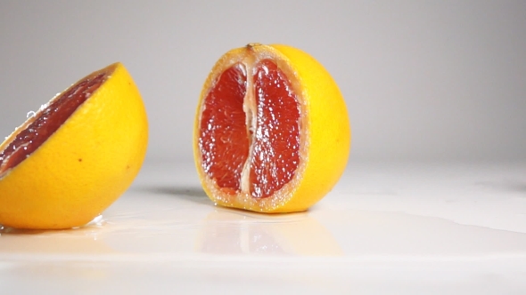 Grapefruit Break On Two Halves On White Surface
