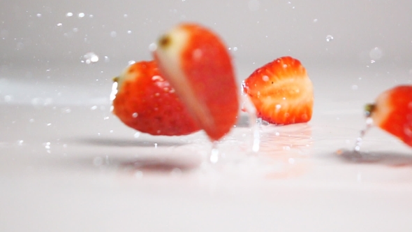 Sliced Strawberries Fall Down On White Surface