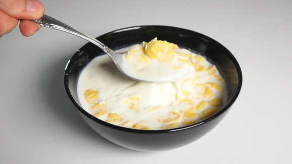 Shuffle Cornflakes In Milk By Spoon