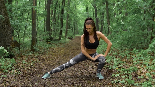 Slim Fitness Woman On a Forest Path. 