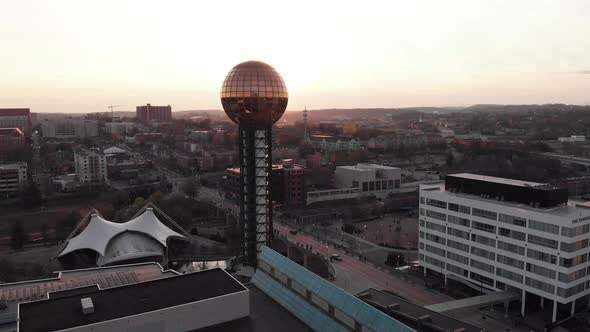 Aerial drone footage over downtown Knoxville overlooking World's Fair park and Sunsphere  panning to