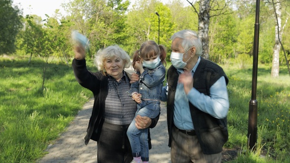 Grandparents with Granddaughter Takes Off Masks After Coronavirus Quarantine End