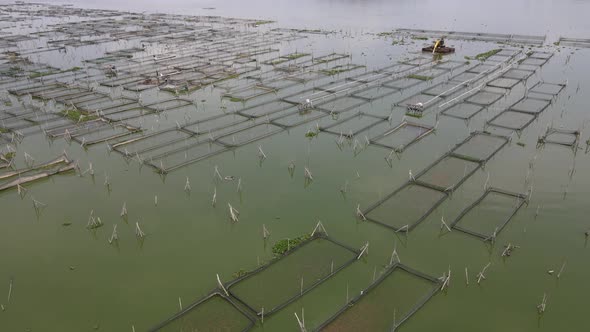 Aerial view of traditional floating fish pond on swamp in Indonesia