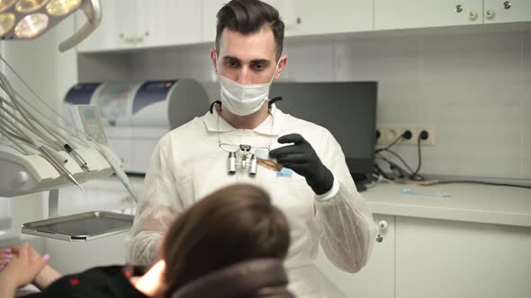 Dentist doctor consults the patient during the appointment