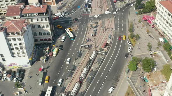 Tram Train Arriving in Public Transport Station in Istanbul, Aerial Tilt Up Revealing City Buildings