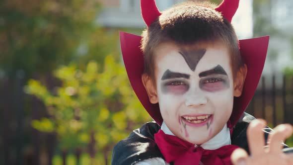 Cute Boy in Halloween Costume Trying to be Scary