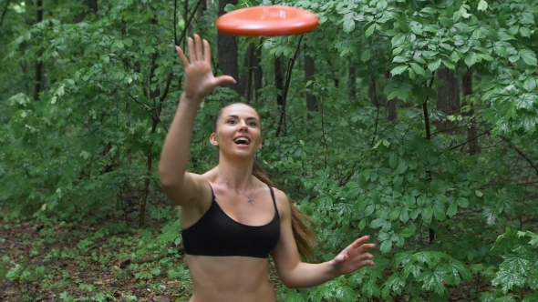 Young Woman Outdoor Catching a Frisbee