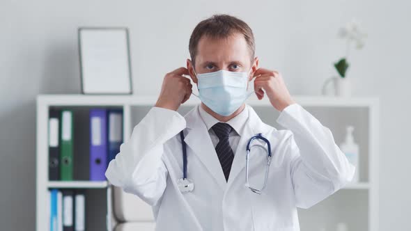 Professional medical doctor working in hospital office using computer technology.