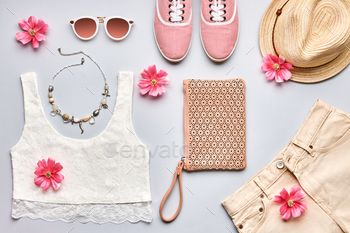 essories. Trendy sunglasses, gumshoes, lace top, handbag clutch, necklace hat and flowers. Romantic lady. Creative urban overhead, top view on gray