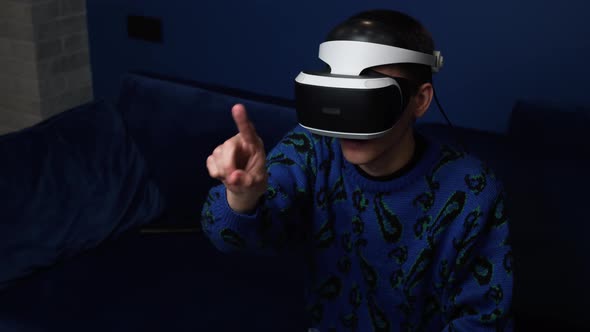 Slow Motion Scene Video of a Caucasian Man Using a VR Headset Helmet Device To Play Video Games at