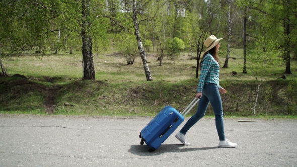 Girl Goes On The Road With a Suitcase