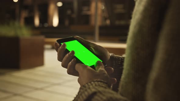 Mans Hand Using Green Mockup Screen Smartphone