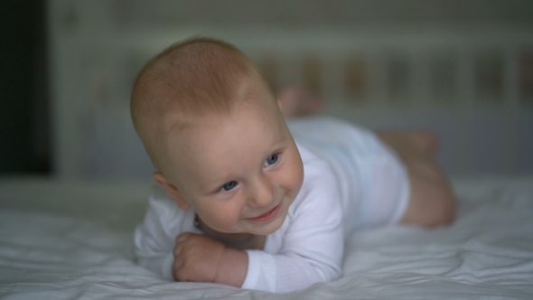 Cute Baby Laughing Lying On The Bed