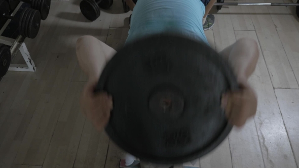 Senior Man Working Out With Weight Disk