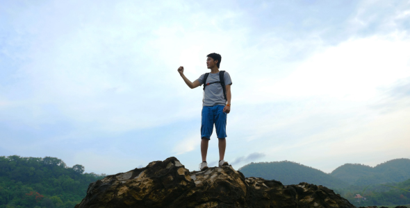Man Celebrating On The Top Of Rock