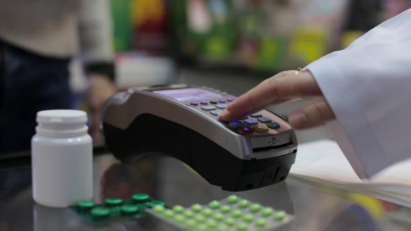 Man Paying with a Credit Card at the Pharmacy