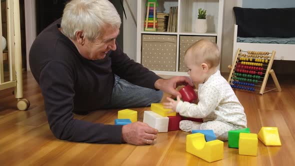 Grandfather Playing with Little Baby