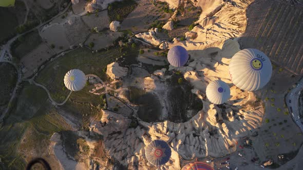 4K Aerial view of Goreme. Colorful hot air balloons fly over the valleys.