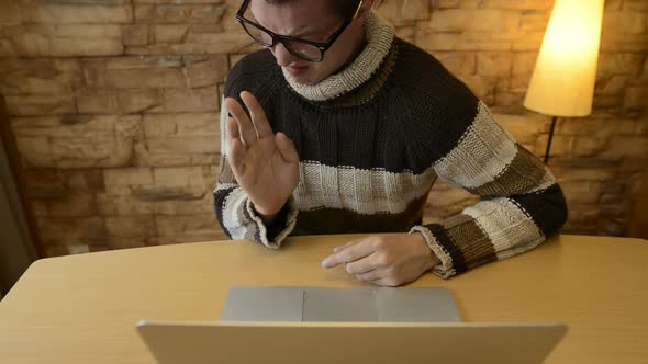 Stressed Young Man Looking Disgusted While Using Laptop at Home