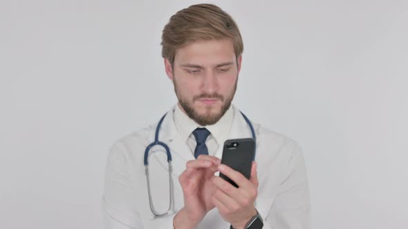 Young Doctor Browsing Smartphone on White Background