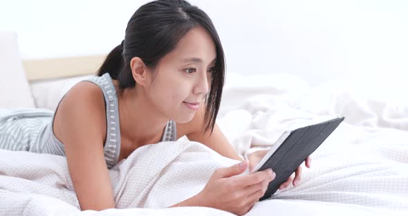 Woman use of mobile phone on bed