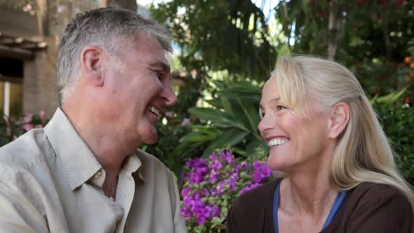 Couple laughing together, man stroking woman's hair